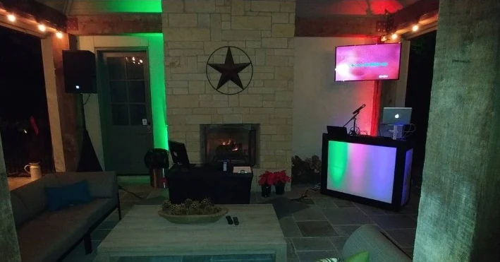 DJ booth with red and green uplighting