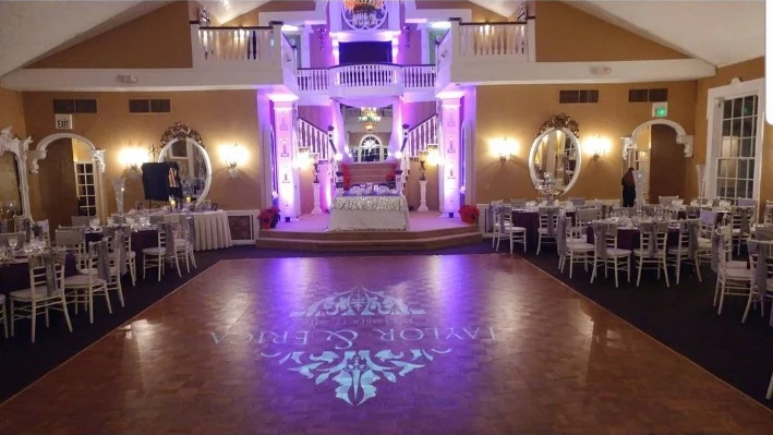 Custom dance-floor monogram and purple uplighting